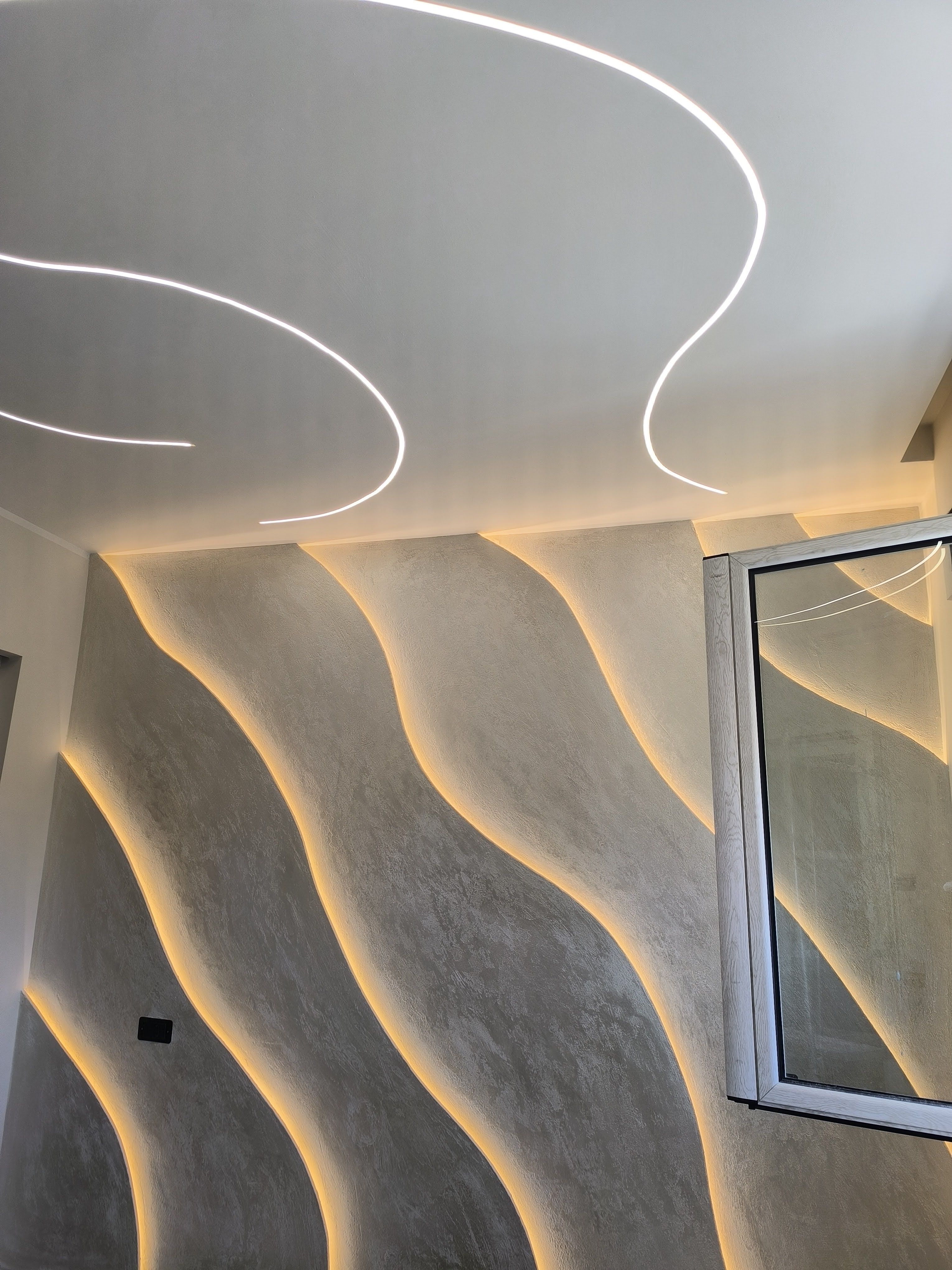 Parete decorativa con LED curva e intonaco ondulato